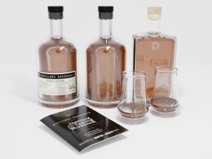 Three bottles, a workbook and two glasses for the Distiller's Experience
