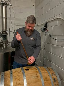 Head Distiller of Durham Distillery, Chris Ferg, doing a barrel pull of whisky
