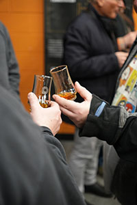 Two customers are clinking glasses to enjoy Durham Distillery whisky