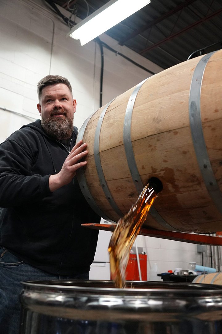 Head Distiller Chris Ferg dumping a new cask of whisky