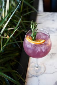 Purple Rain Gin cocktail in a large gin goblet with garnish