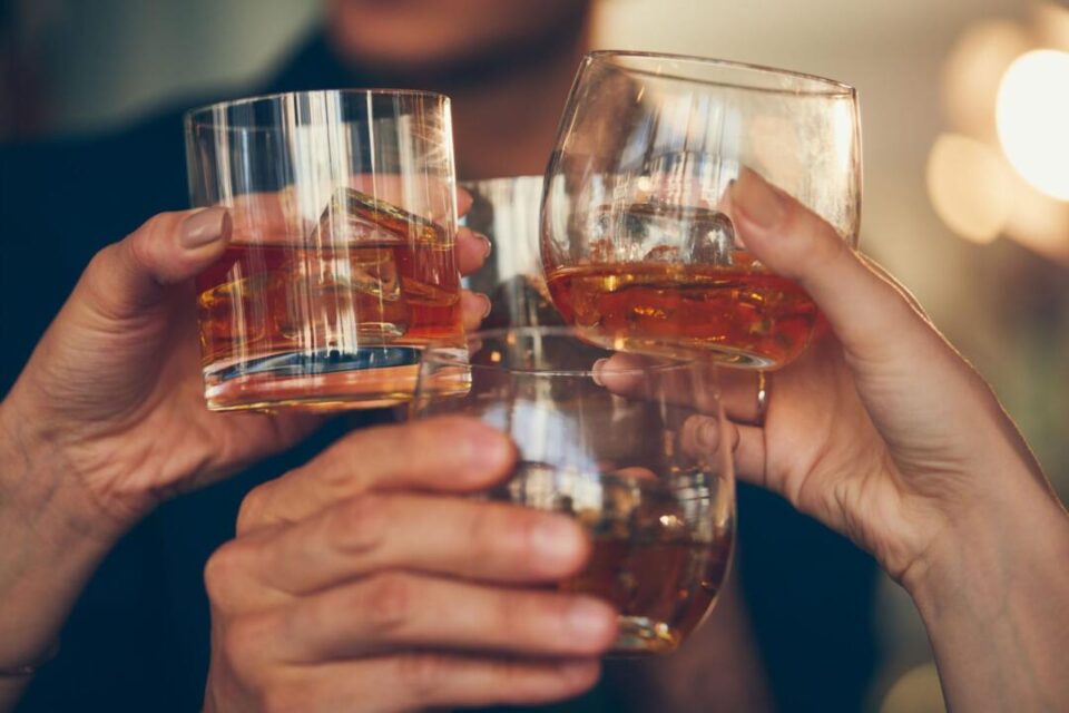 three-people-makes-a-toast-with-whiskey-royalty-free-image-1576022739-scaled-1920x1280